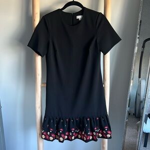 Semi flare short dress with embroidery on the bottom.